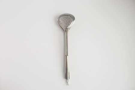 Stainless steel kitchen utensils on a white background.