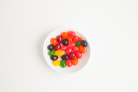 Colorful jelly beans shot with selective focus on white background.の写真素材