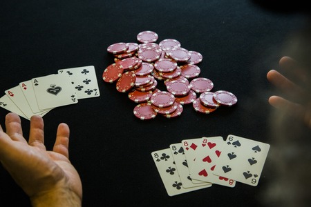 A man with casino chips at a poker table.の写真素材