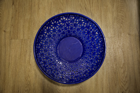 Empty basket shot overhead, from top, isolated on wood background.の写真素材