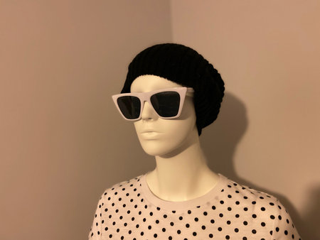 Transgender mannequin with modern, hip hat, sunglasses, and shirt.の写真素材