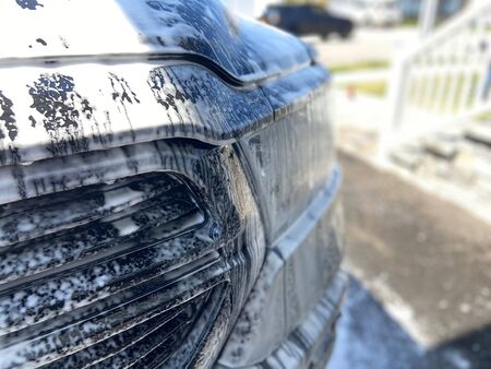 A truck with soapy suds all over it on a sunny day.の写真素材