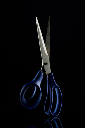 Scissors on the black background