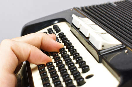 Male hand playing accordionの写真素材