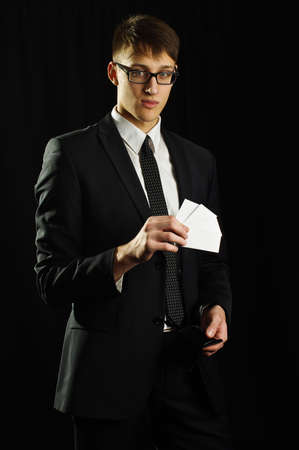 Caucasian man holding few white business cardsの写真素材