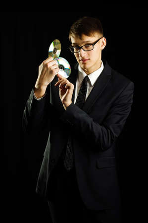 Young man holding two CDの写真素材