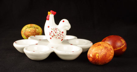 Eggs stand and three decorated Easter eggsの写真素材