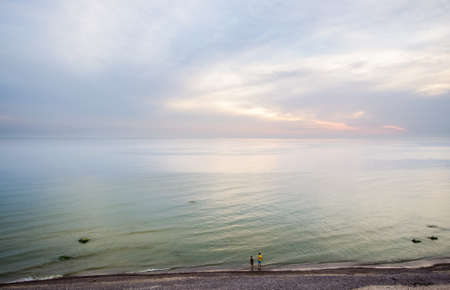 Small silhouette of lonely lovers in the beachの写真素材