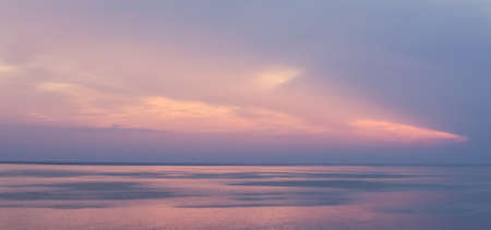 Pink creamy sunset over the seaの写真素材