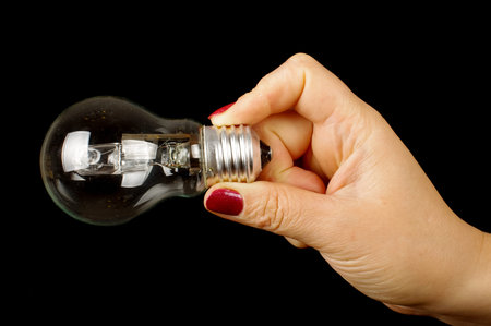 Woman hand hold incandescent bulb isolated