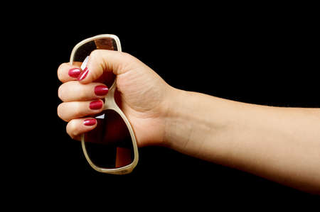 Female hand holding sun glassesの写真素材