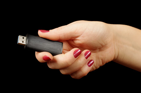 Woman hand holding USB flash drive stick