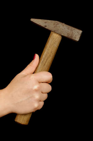 Woman hand holding hammer isolated on the blackの写真素材