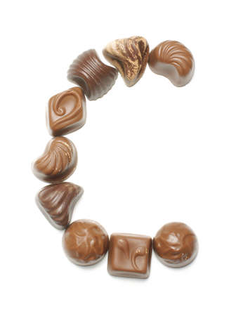 Alphabet letter C arranged from chocolate sweets isolatedの写真素材