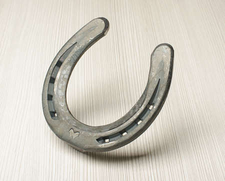 Standing horseshoe on the wooden backgroundの写真素材