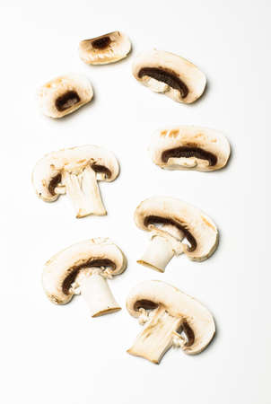 Raw champignon mushroom slices on the bright backgroundの写真素材