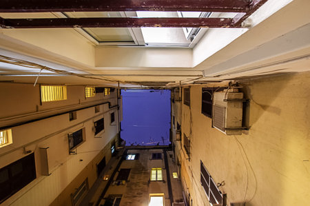 Overpopulation concept : small area of free sky surrounded by hotel wallsの写真素材