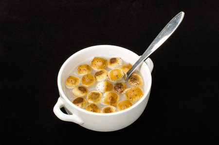 Kūčiukai in the white bowl isolated on the dark background