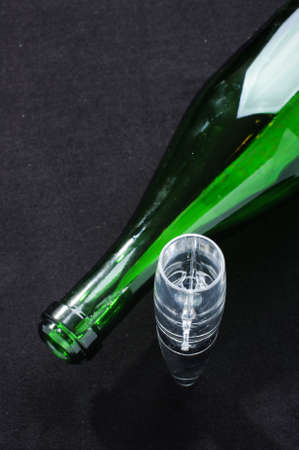 Green wine bottle and wine aerator on the black backgroundの写真素材
