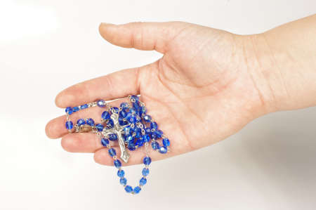 Rosary and silver cross in the male handの写真素材