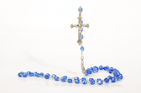 Religion concept flying cross over rosary