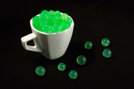 Green balls in the mug futuristic conceptの写真素材