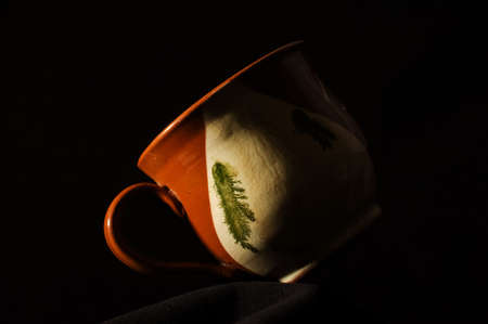 Vintage coffee cup in hard lightの写真素材