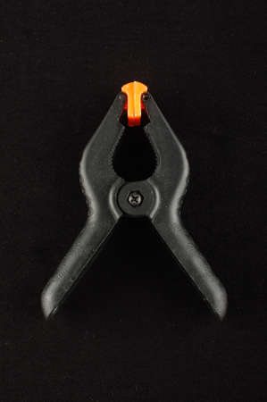 A clamp isolated on the black backgroundの写真素材