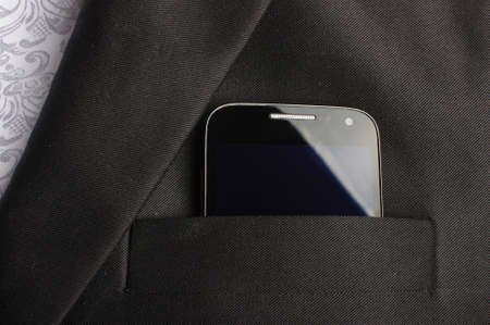 Smart phone in suit pocketの写真素材