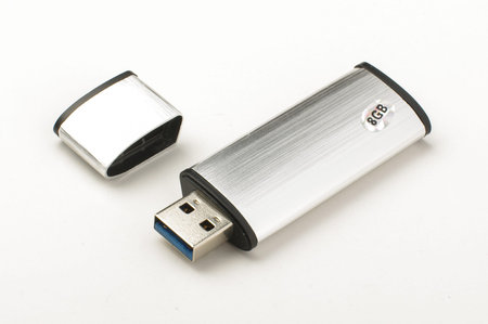 Grey metalic aluminum flash stick isolated on the bright background