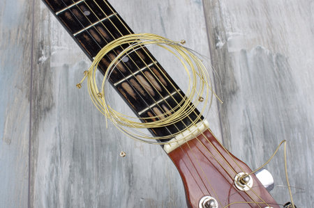 Guitar strings on the reclaimed wooden background
