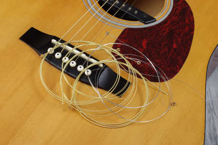 Guitar strings in rolls on the acoustic guitarの写真素材
