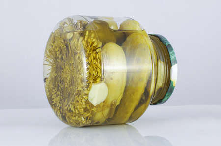 Pickled cucumbers in the jar isolated on the grey backgroundの写真素材