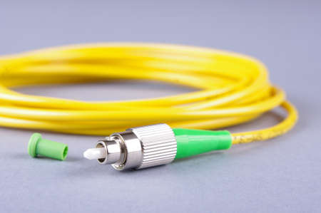 Fiber optics FC connector isolated on the gray backgroundの写真素材