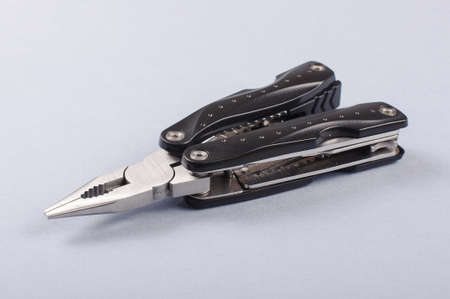 Pliers in army knife isolated on the gray backgroundの写真素材