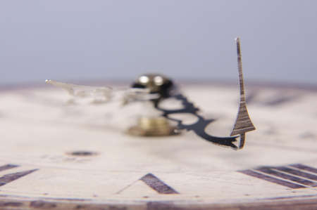 Clock with broken arrow close upの写真素材