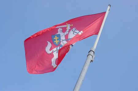 Historical state flag of Lithuania waving over blue skyの写真素材
