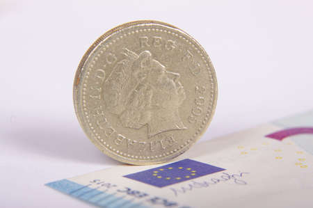 Great Britain pound on the Euro banknote and European Union flag macro close upの写真素材