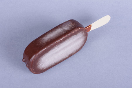 Ice cream with chocolate coating isolated on the gray background
