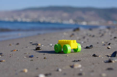 Baby toy car on the sandy beachの写真素材