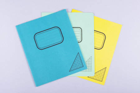 Three exercise books isolated on the gray background