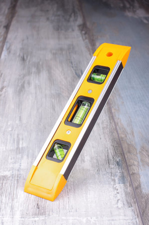 Spirit level tool isolated on reclaimed wood backgroundの写真素材