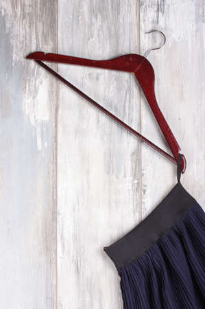 Black skirt hanged on the hanger isolatedの写真素材