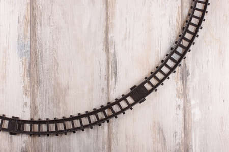 Empty toy train railroad on the vintage reclaimed wood backgroundの写真素材