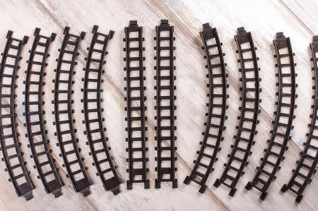 Construction element of toy train railroad on the vintage reclaimed wood backgroundの写真素材