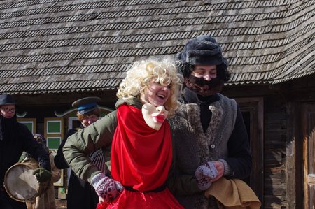 KAUNAS, LITHUANIA - FEBRUARY 25: Happy man and woman dancing in carnival of Uzgavenes on Feb 25, 2017, Kaunas, Rumsiskes, Lithuaniaのeditorial素材