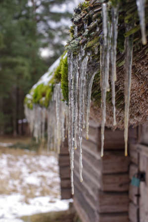 Icicles on the house roof spring symbolの写真素材