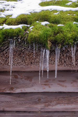 Icicles on the house roof spring symbol