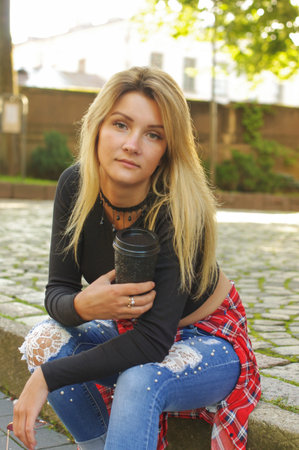 Urban styled girl with disposable coffee cup