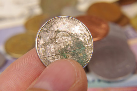 Male hand holding rusty old coin